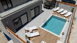 an overhead view of a swimming pool on a house at Tersus Luxury Villa in Kalyves +24 photos