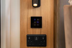 a close up of a wooden door with a black switch at YOTELPAD London Stratford in London