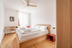 a bedroom with a bed with a ceiling fan at Casa Clara, old town experience in Riva del Garda
