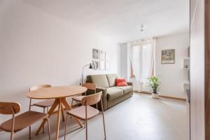 a living room with a couch and a table and chairs at Casa Clara, old town experience in Riva del Garda