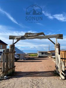 une porte en bois avec un panneau indiquant le sud dans l'établissement Yurt camp Sonun, à Bokonbayevo