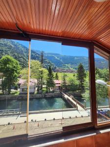 a view of a swimming pool from a window at Uzungöl Merkez Konut 3 Banyo-WC 3 Balkon in Uzungol