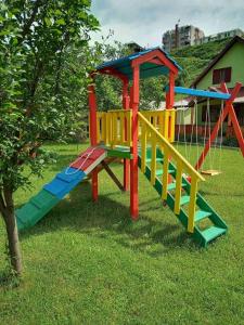 a set of colorful playground equipment in the grass at Household Nikolic - Andrijevica, Montenegro in Andrijevica