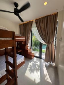 a bedroom with two bunk beds and a window at Villa Anela in Puerto Princesa City +19 photos