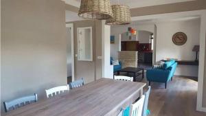 a dining room and living room with a table and chairs at Villa au calme et sans vis à vis , proche du village in La Bastide-des-Jourdans
