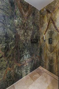 a bathroom with a wall with a painting of trees at Astria Eclipse - Complex Novum in Olimp +17 photos