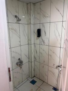 a bathroom with a shower with white marble tiles at Asya Hotel in Konya +13 photos