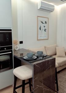a kitchen with a counter and a couch in a room at Godija Central Tirana 1 in Tirana
