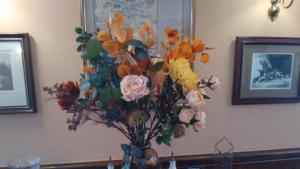 a bouquet of flowers in a vase on a table at George Inn, Mere in Mere