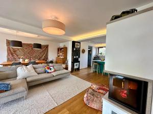 a living room with a couch and a fireplace at Hello Balaton in Alsóörs