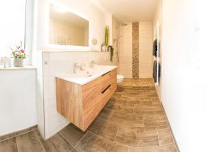 a bathroom with a sink and a refrigerator at Wasserblick Loddin Deluxe 8 in Loddin