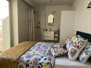 a bed with pillows on it in a bedroom at Appartement atypique cosy entre terre & mer in Marseille