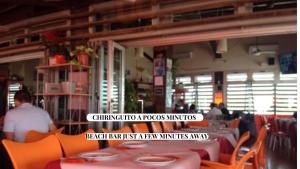 a restaurant with tables and chairs and a man in the background at Apartamento Babor Sun & Beach in Almerimar