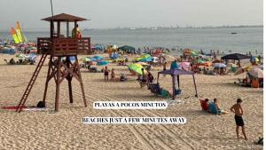 a group of people on a beach with umbrellas at Apartamento Babor Sun & Beach in Almerimar +52 photos