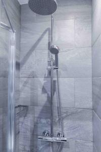 a shower with a glass door in a bathroom at Sinclair's Rooms in Southport