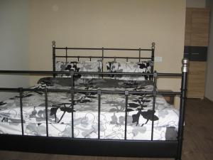 a bed with a metal bed frame and pillows at La Avocați in Vama Veche