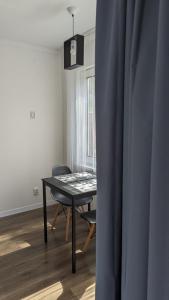 a table and chair in a room with a window at Pine forest house 5 in Gauja