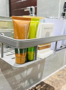 a shelf with cups on it in a kitchen at Dips And T Hotel & Spa in Bloemfontein +63 photos