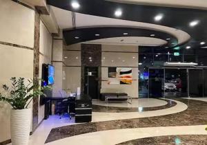 an office with a desk and a tv in a room at Cosmos Living Charming Studio With Balcony in Dubai +38 photos