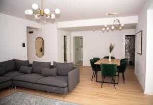 a living room with a couch and a table at V25Appartments in Bucharest