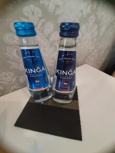 two bottles of water sitting on top of a table at Kameralny Apartament in Szczytno