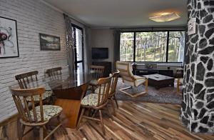 a living room with a dining room table and chairs at Art Spa Villa Gal in Velingrad