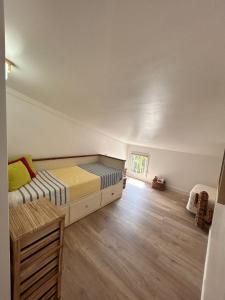 a bedroom with a bed and a wooden floor at La pitchounette in Fleury
