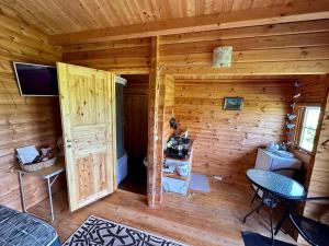 a log cabin with a room with a bathroom at Haapsu Holiday Home in Haapsu +15 photos