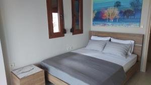 a small bed in a bedroom with a window at Villa Anna III in Nea Moudania