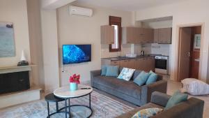 a living room with a couch and a table at Villa Anna III in Nea Moudania