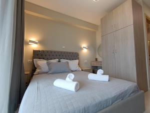 a bedroom with a bed with two towels on it at ALTA MARE in Nea Peramos