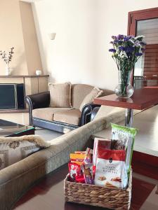 a living room with a couch and a basket of food at Eleousa Apartment Ioannina in Eleoúsa