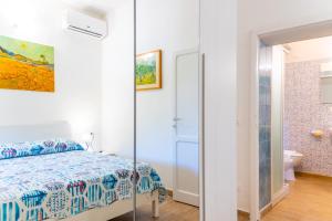 a bedroom with a bed and a bathroom at Appartamento Il Mare Dalla Terrazza in Rio nellʼElba +10 photos