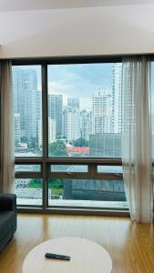 a living room with a large window with a view of a city at Swiss Garden Residence in Kuala Lumpur
