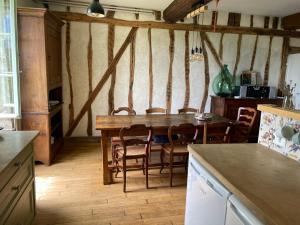 a kitchen with a table and chairs in a room at Chez Katia in Semur-en-Auxois +11 photos