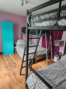a room with two bunk beds and a blue door at LA MEUTE in Mars-sur-Allier +15 photos