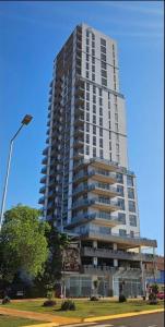 a tall building with a street light in front of it at Rio Suits Apartments C in Posadas