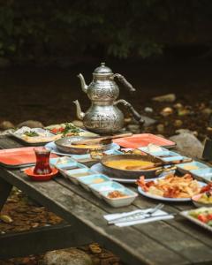 a table with plates of food and a tea kettle at Modul Suit & Bungalov in Rize