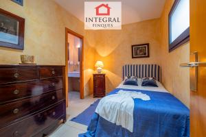 a bedroom with a bed and a dresser and a bathroom at Sal de Mar - Casa La Fosca in Palamós