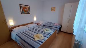 two beds in a small room with towels on them at Apartment Miro- 5 km from Opatija in Matulji