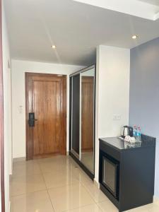 a kitchen with a counter and a wooden door at ZARA HOTEL in Antananarivo