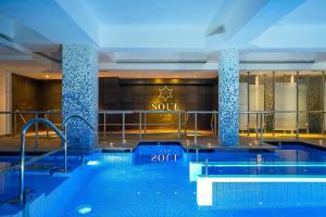 a swimming pool in a building with a sign that reads soul at Jupiter Algarve Hotel in Portimão