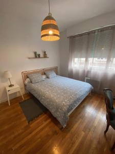 a bedroom with a bed and a pendant light at Appartement vue beffroi in Amiens