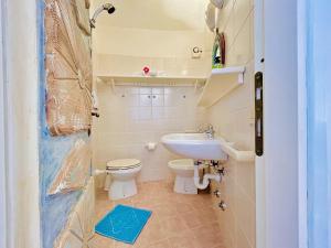 a small bathroom with a toilet and a sink at Vistamare Cala Granu in Porto Cervo +23 photos
