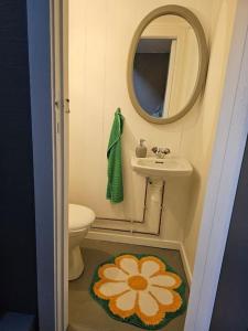 a small bathroom with a sink and a mirror at Leilighet sentralt i Svolvær in Svolvær +3 photos