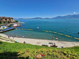 a group of people in the water at a beach at Les Tilleuls 4 in Saint-Gingolph