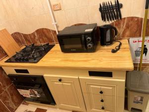 a microwave sitting on top of a counter next to a stove at Mansoura sweet-home hotel apartments in Bandar al Manşūrah