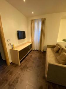 Una sala de estar con un sofá y un televisor. en Appartamento Milano IEO Prada, en Vigentino