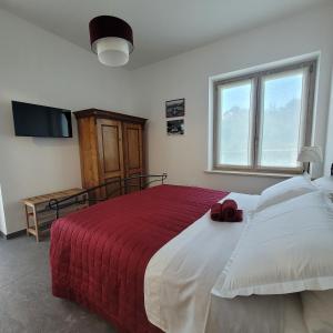 a bedroom with a large bed with a red blanket at La Sovrana dei Cimini in Bagnaia +85 photos