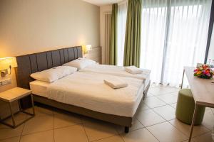 Voodi või voodid majutusasutuse Hotel Nessi Locarno toas